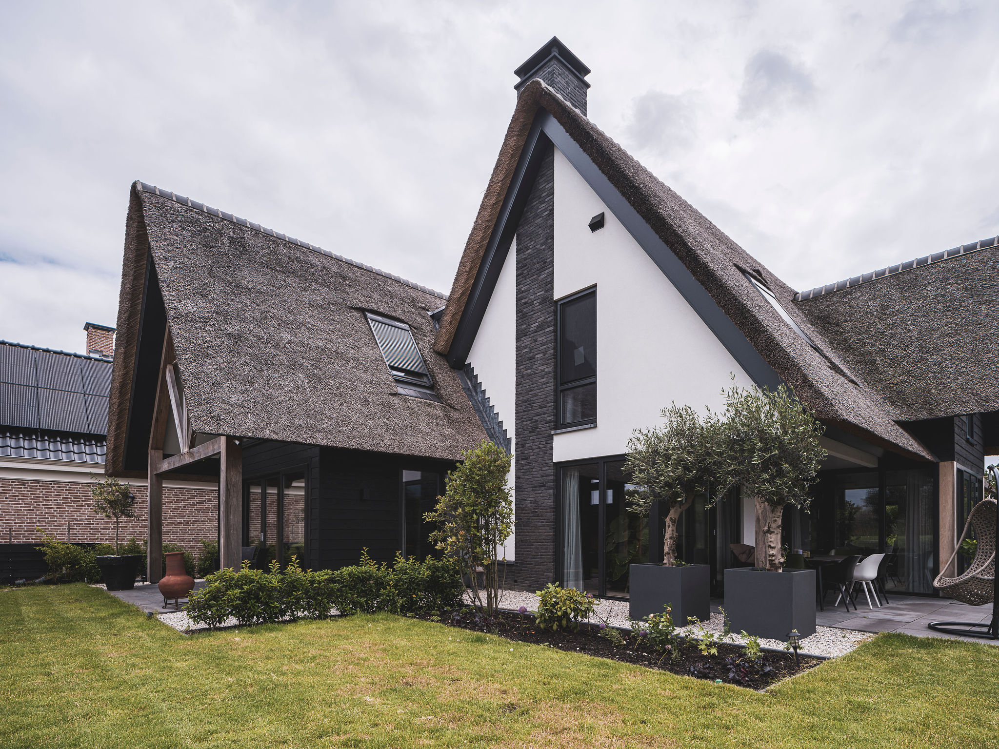 Moderne rietgedekte woning met witte gevel, houten spanten en royale kap &ndash; ontworpen door architect in de omgeving van Dordrecht